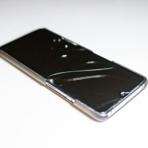 a close up of a cell phone on a white surface