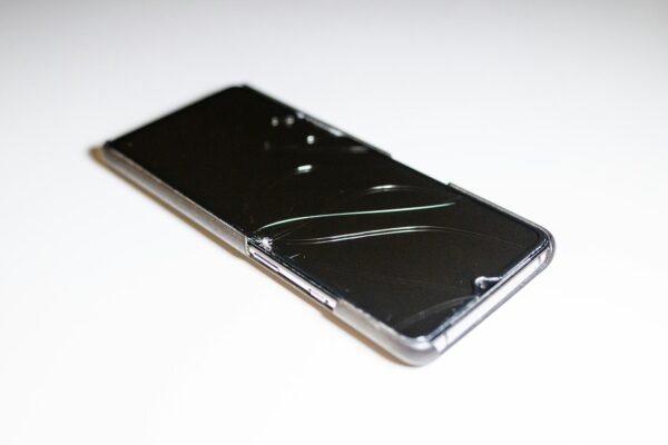 a close up of a cell phone on a white surface